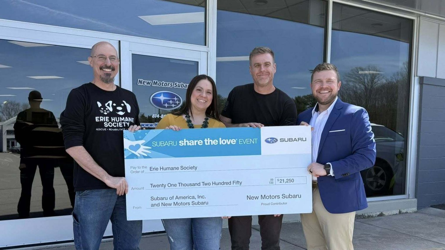 Representatives holding a large check