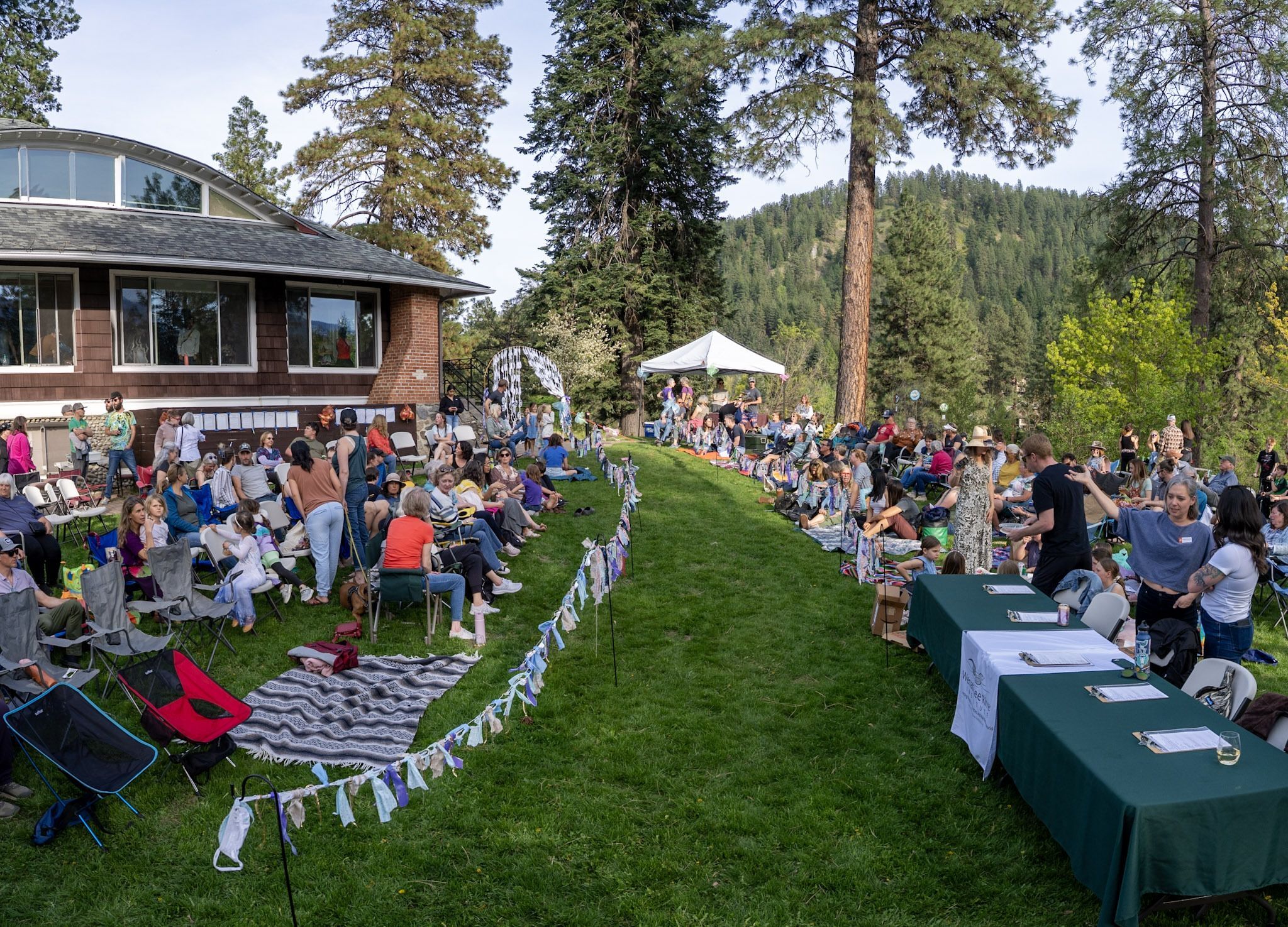 The Trashion Show runway on the lawn at WRI with participants waiting to watch.