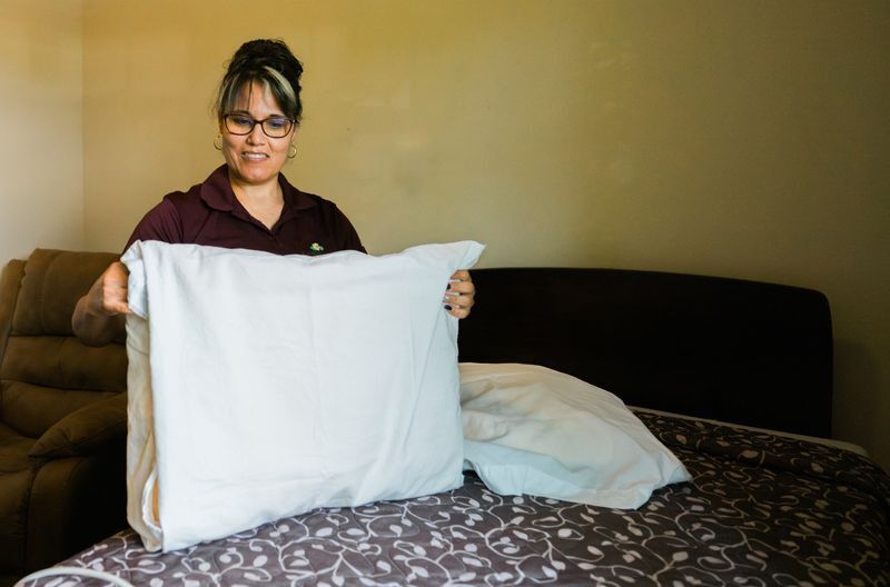Woman cleaning linens at Casey's Pond Senior Living Community in Steamboat Springs, CO