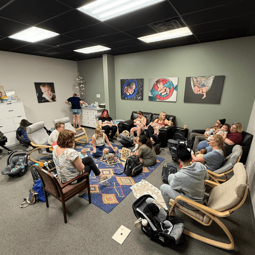 Group of women with babies sitting on the floor
