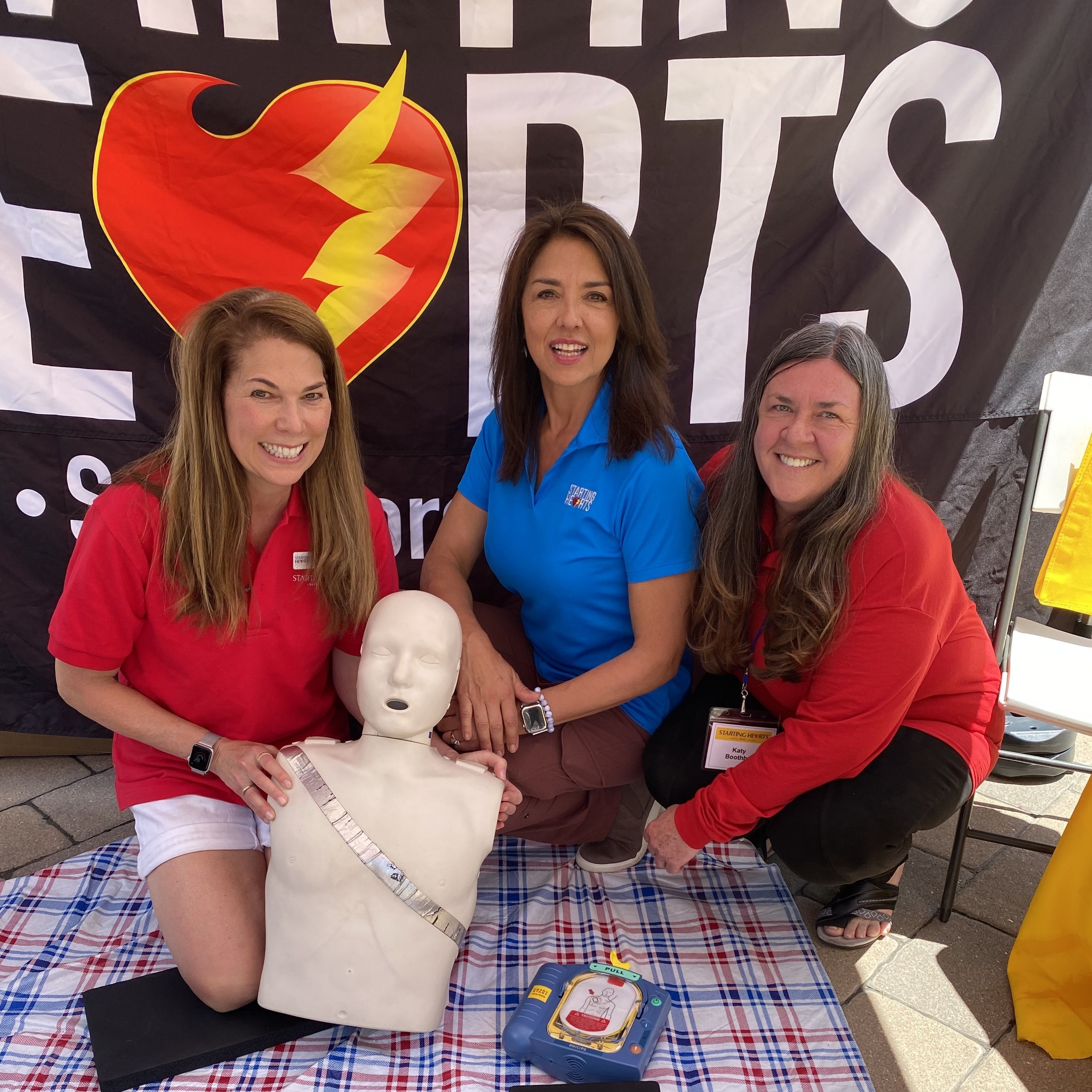 State Representative Dylan Roberts and City Market defib donors, Mikki and Morris Futernick