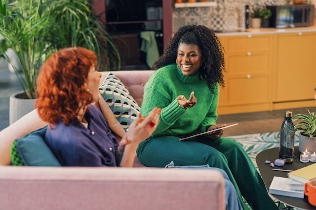 Diverse people chatting while seated on a couch