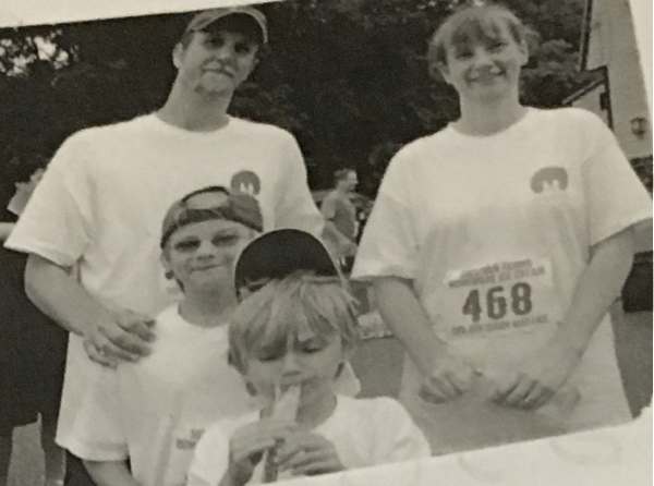 Black and white photo of Mark, Bella, Jack and Jodie in road race t-shirts
