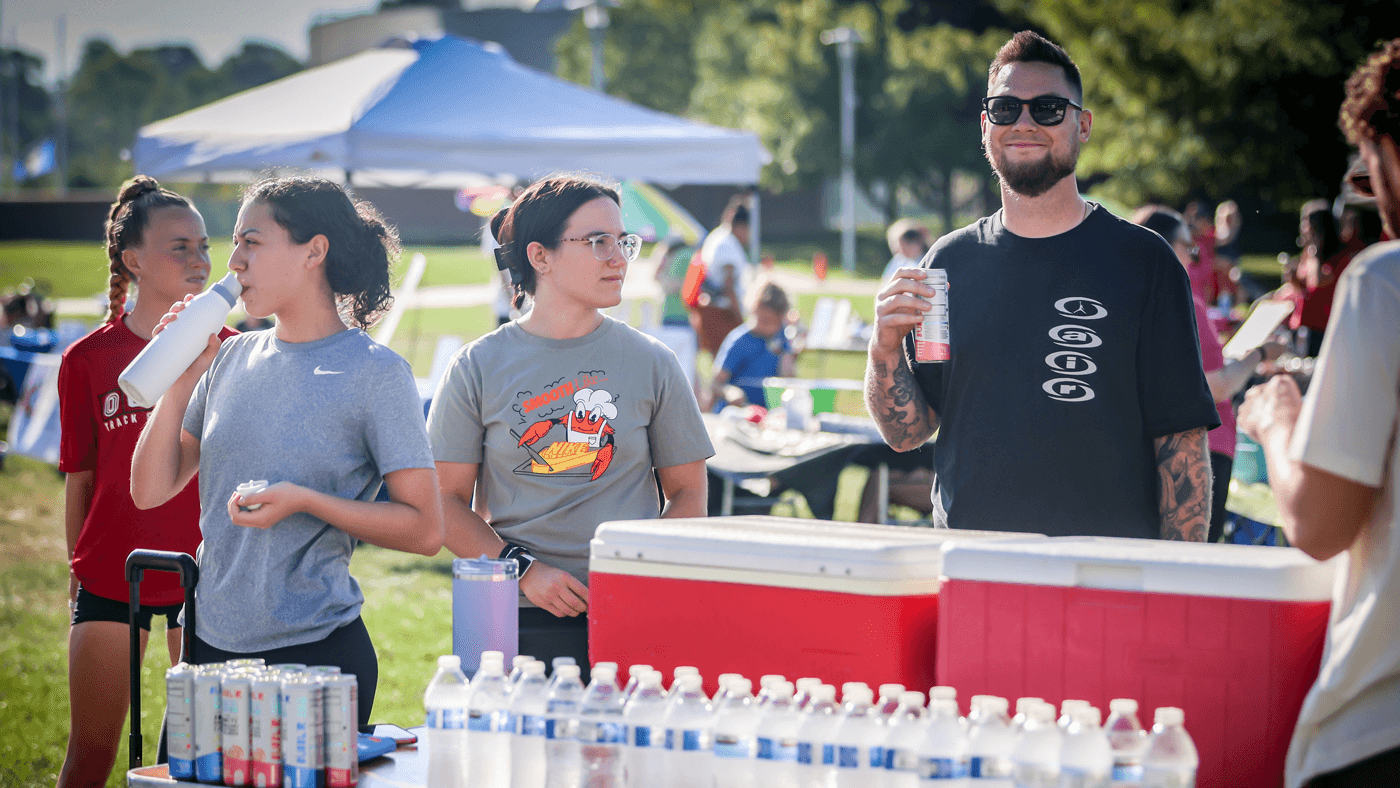 Community volunteers handing out water to race participants