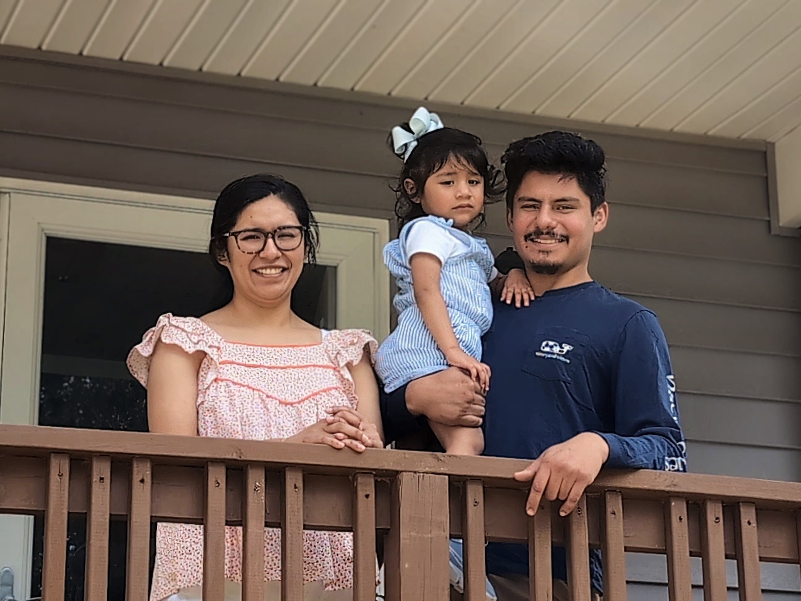 The Castro Family stands on their new front porch