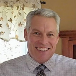 head shot portrait of Paw Print owner Tom Brassard