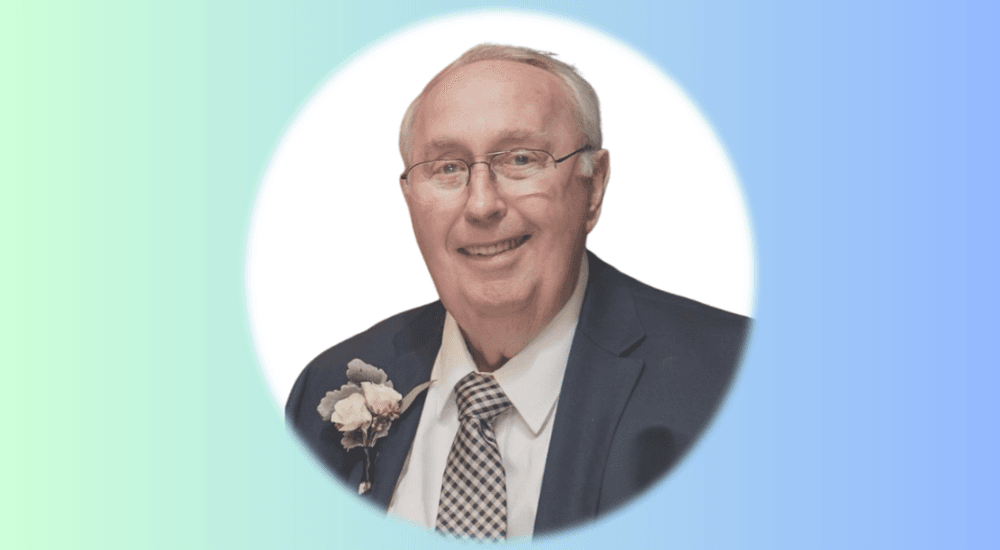 Portrait of Burt Thomas, honored in memory by the Cabarrus County Education Foundation, wearing a suit with a boutonniere on a soft gradient background.