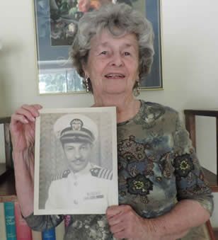 Patricia Holtwick Moran with photo of her father, Navy Captain Jack Holtwick