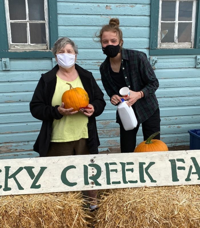 Two women holding pumpkin