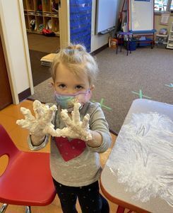 Toddler playing with playdough.