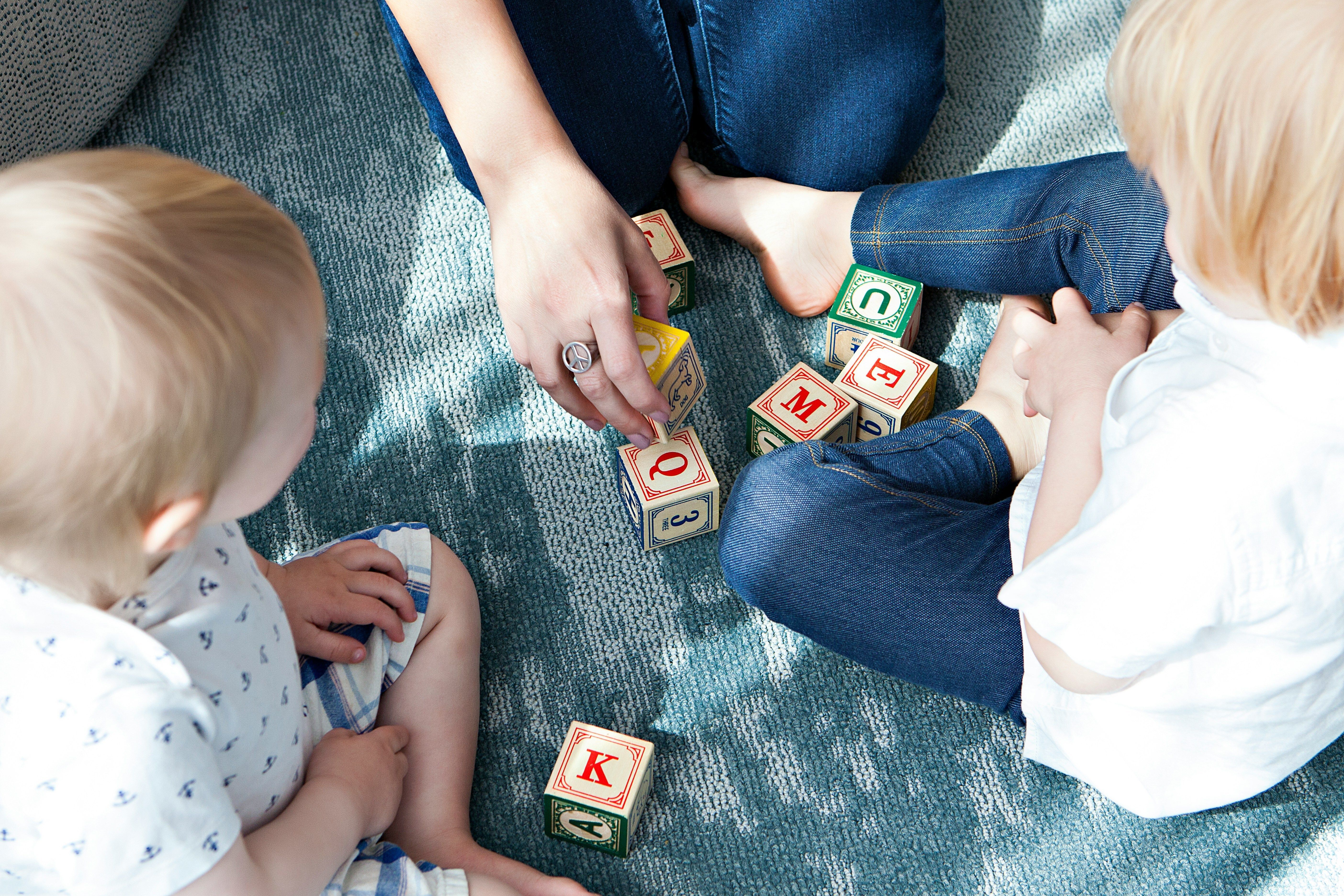 kids playing with alphabet blocks