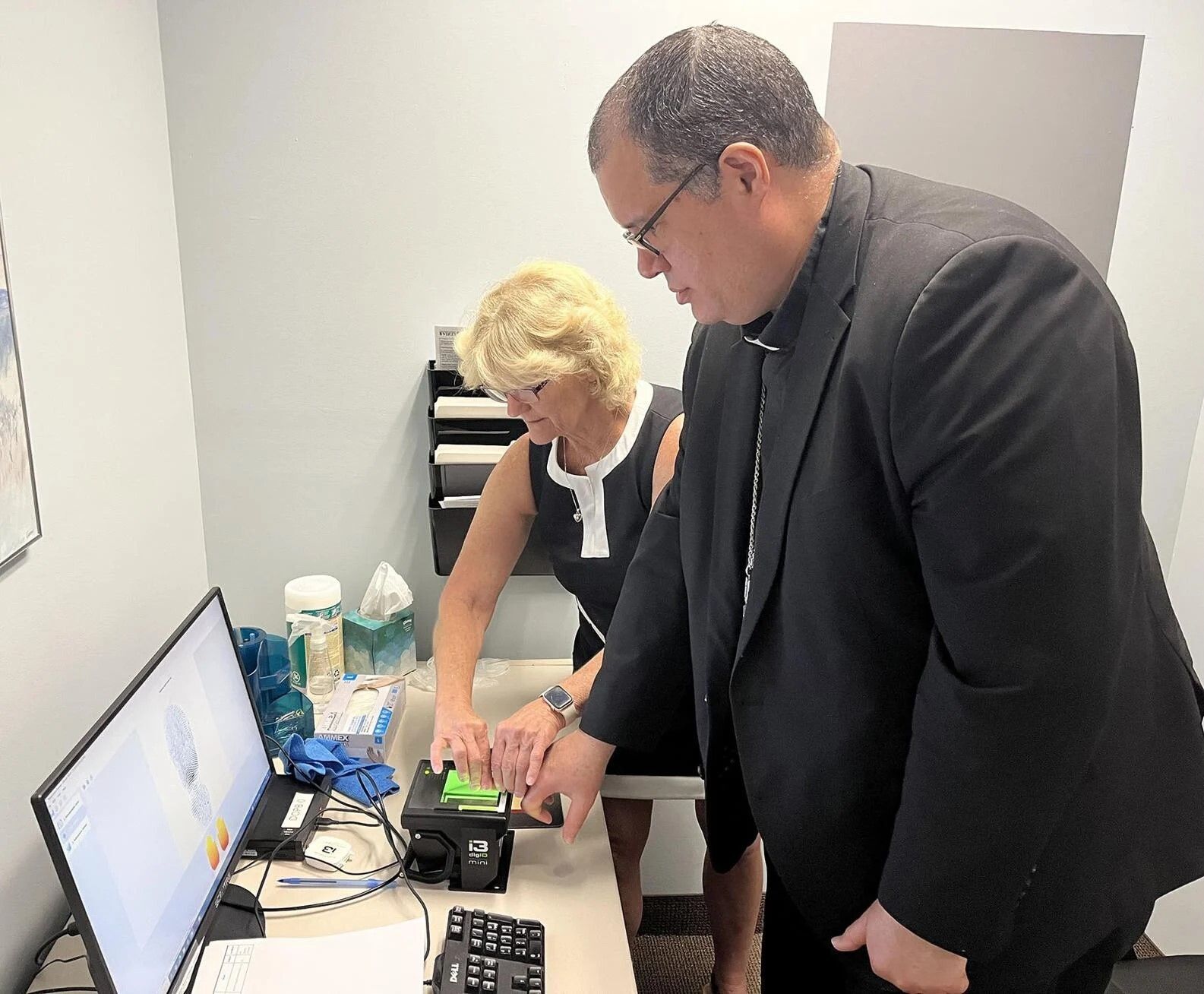 Bishop Manuel de Jesús Rodríguez is fingerprinted as required by the church's safe environments program