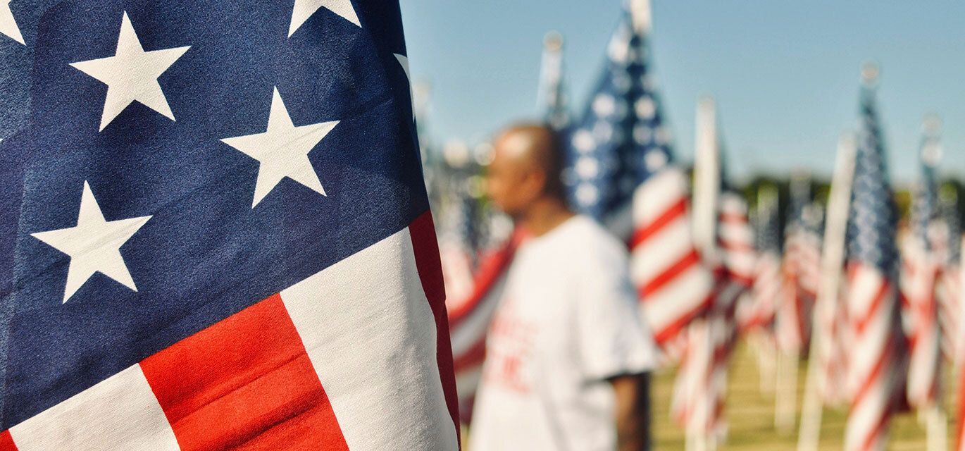 American flag with several in the background.