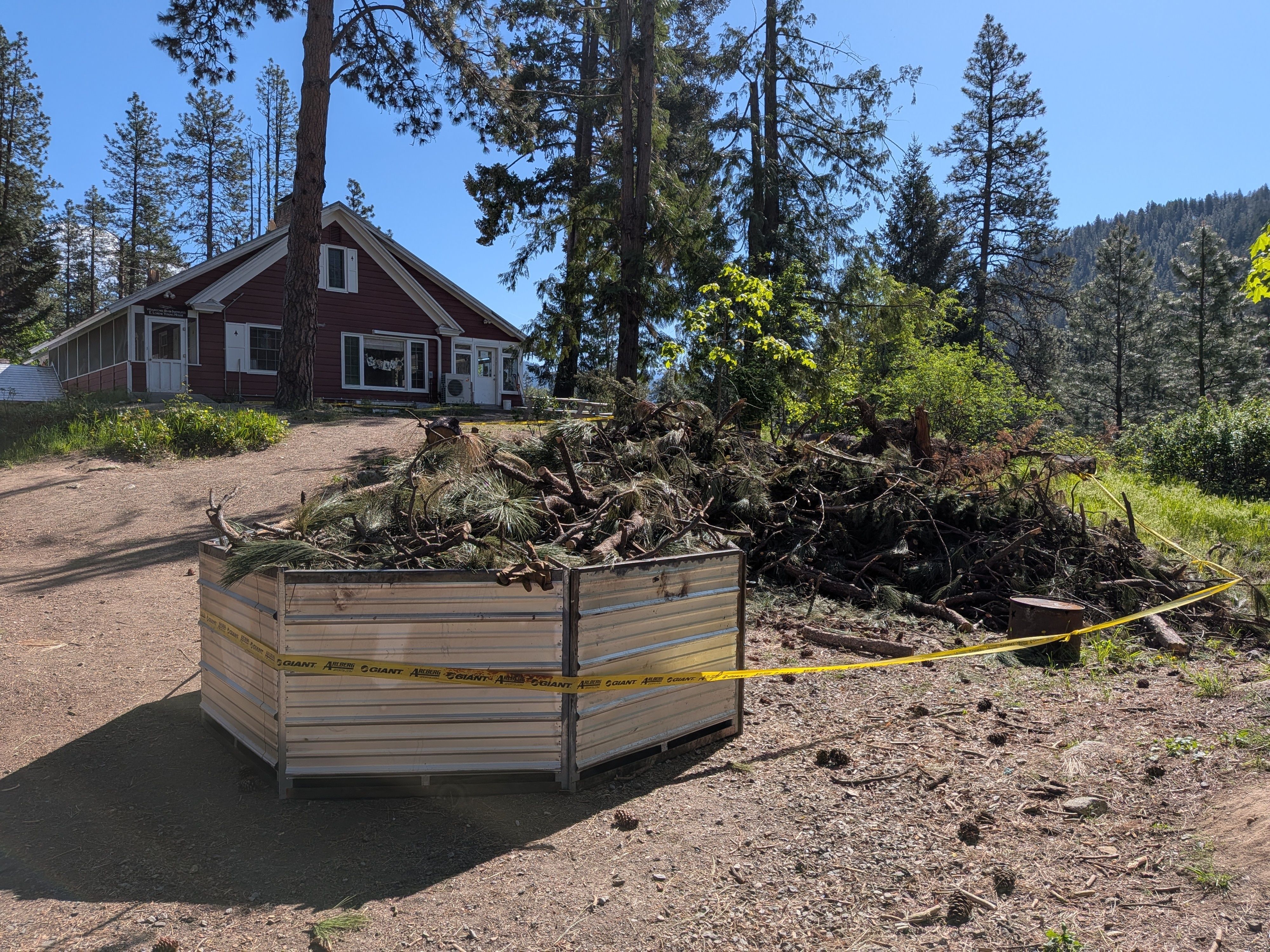 Picture of biochar kiln filled with debris to burn near the ELY House at Wenatchee River Institute.