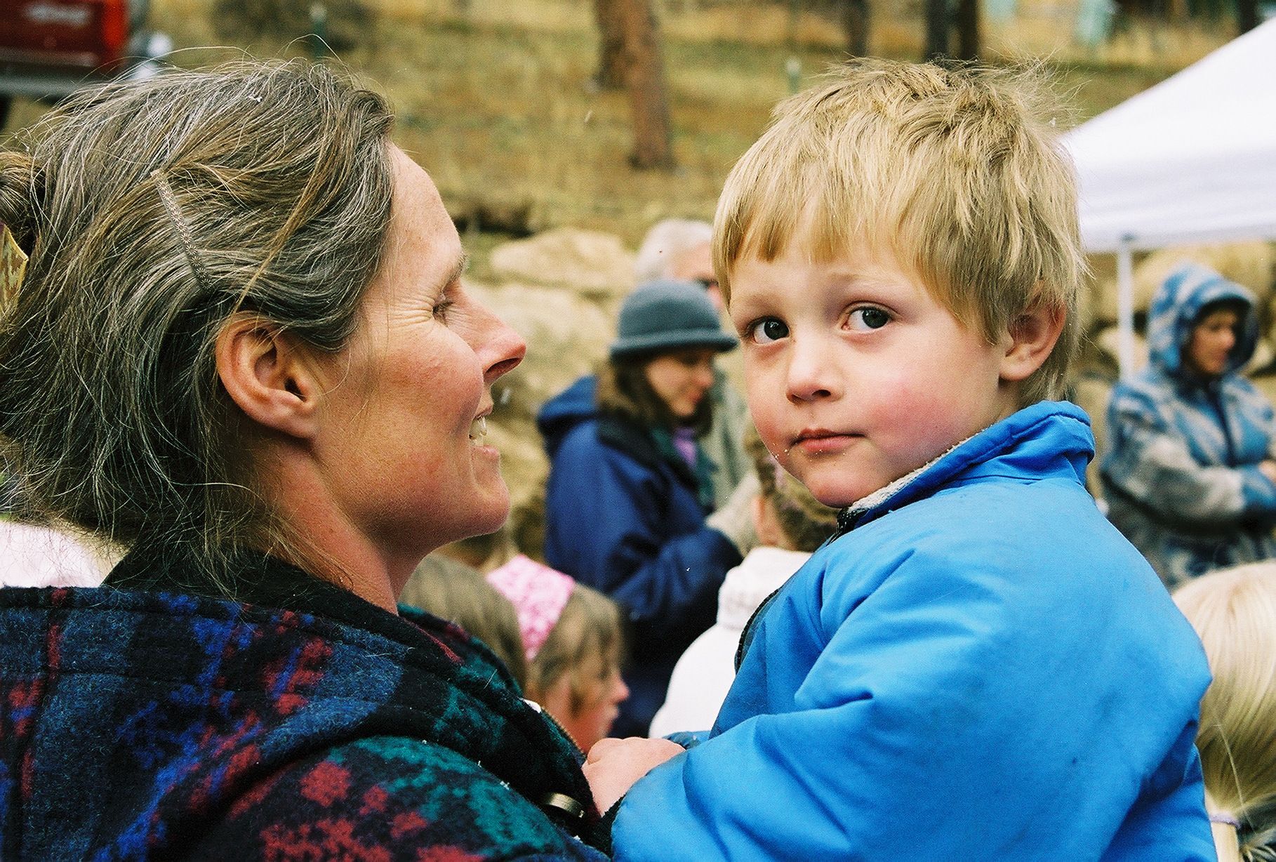 Mother holding child on site of soon-to-be home