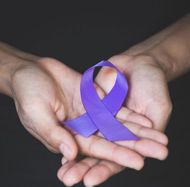 Hands holding a purple ribbon