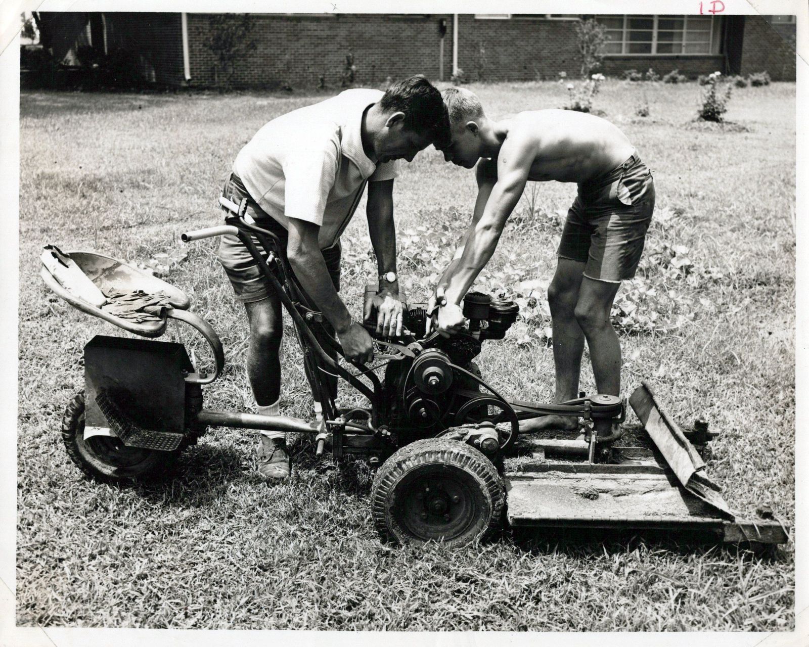 Kids working on a lawn mower at BGHNC, circa 1960s.