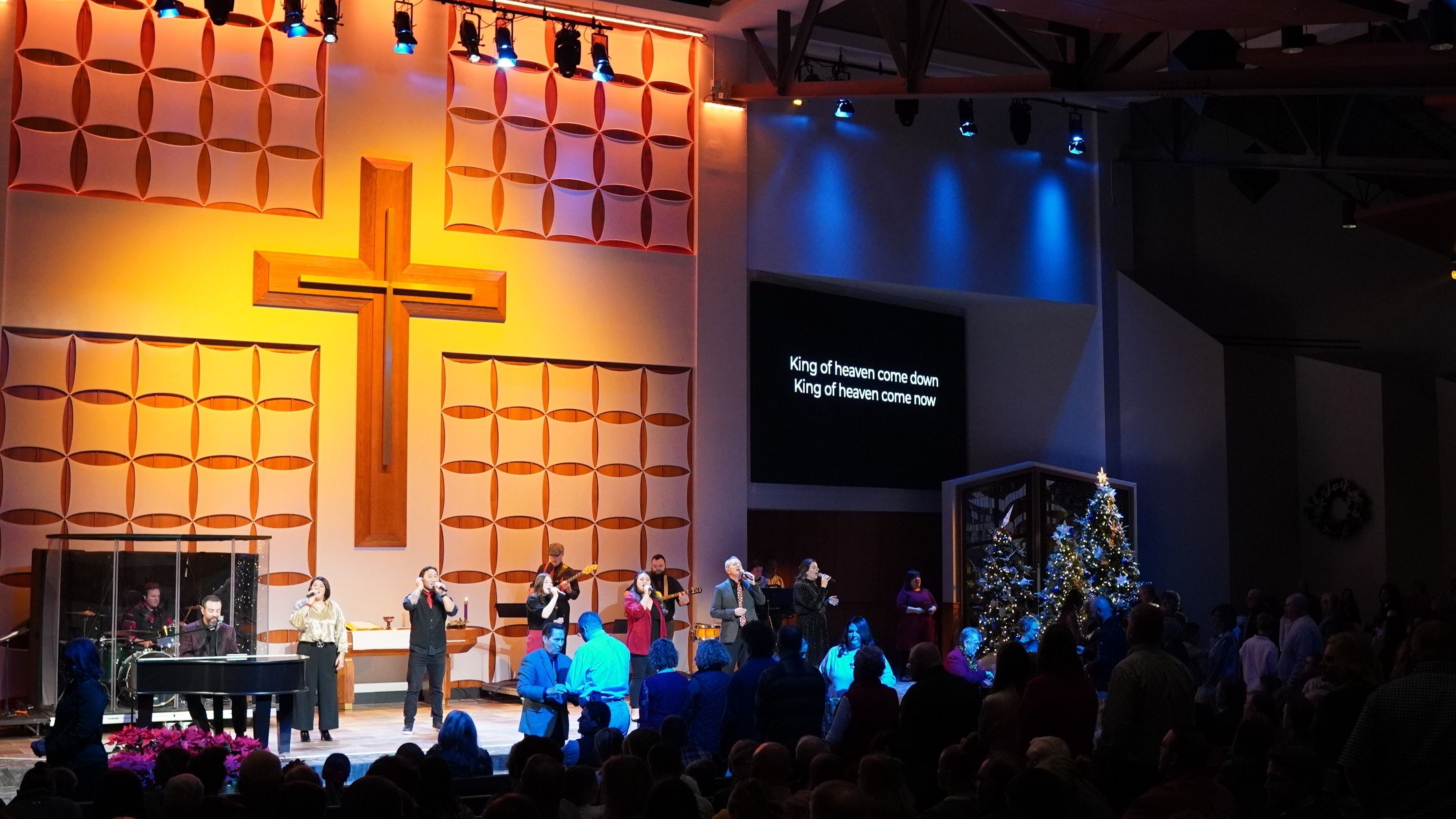 Church congregation greeting each other.