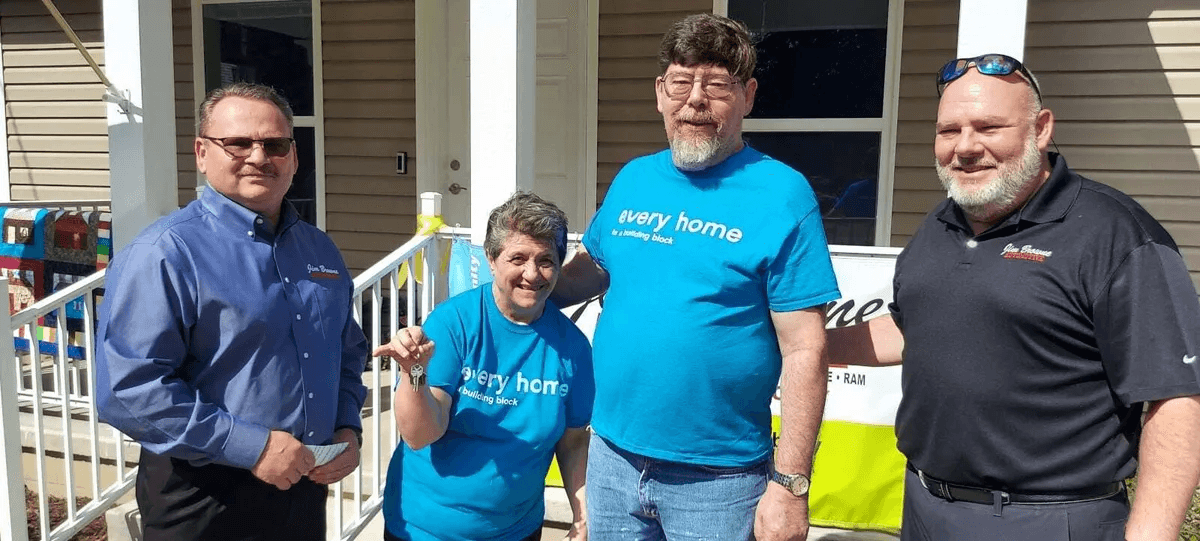 family in front of their new house.