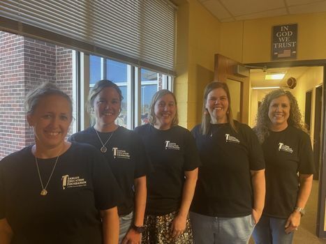 A group of children holding up papers