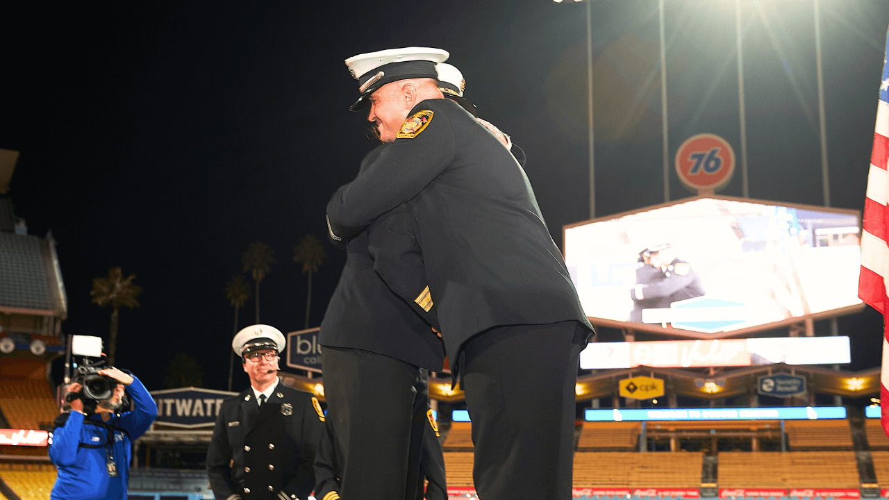 Captain I Florin Sarbu of the LAFD embraces Fire Chief Kristin Crowley after receiving his award.