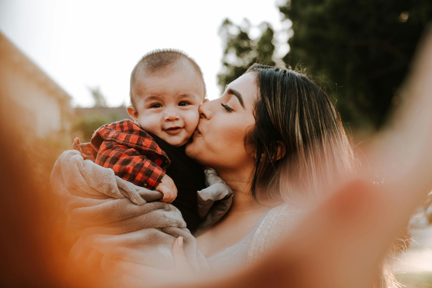 mom holding her baby taking a selfie