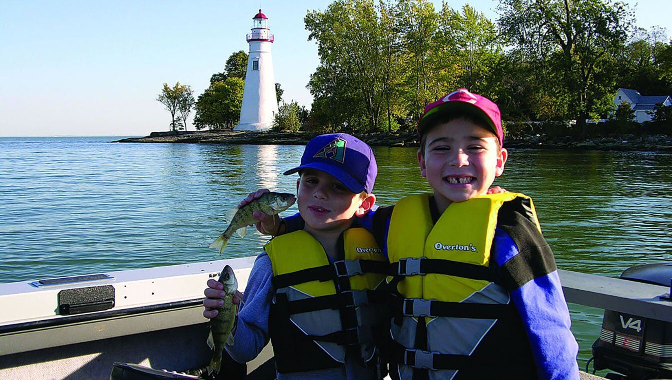 Kids holding Perch fish.