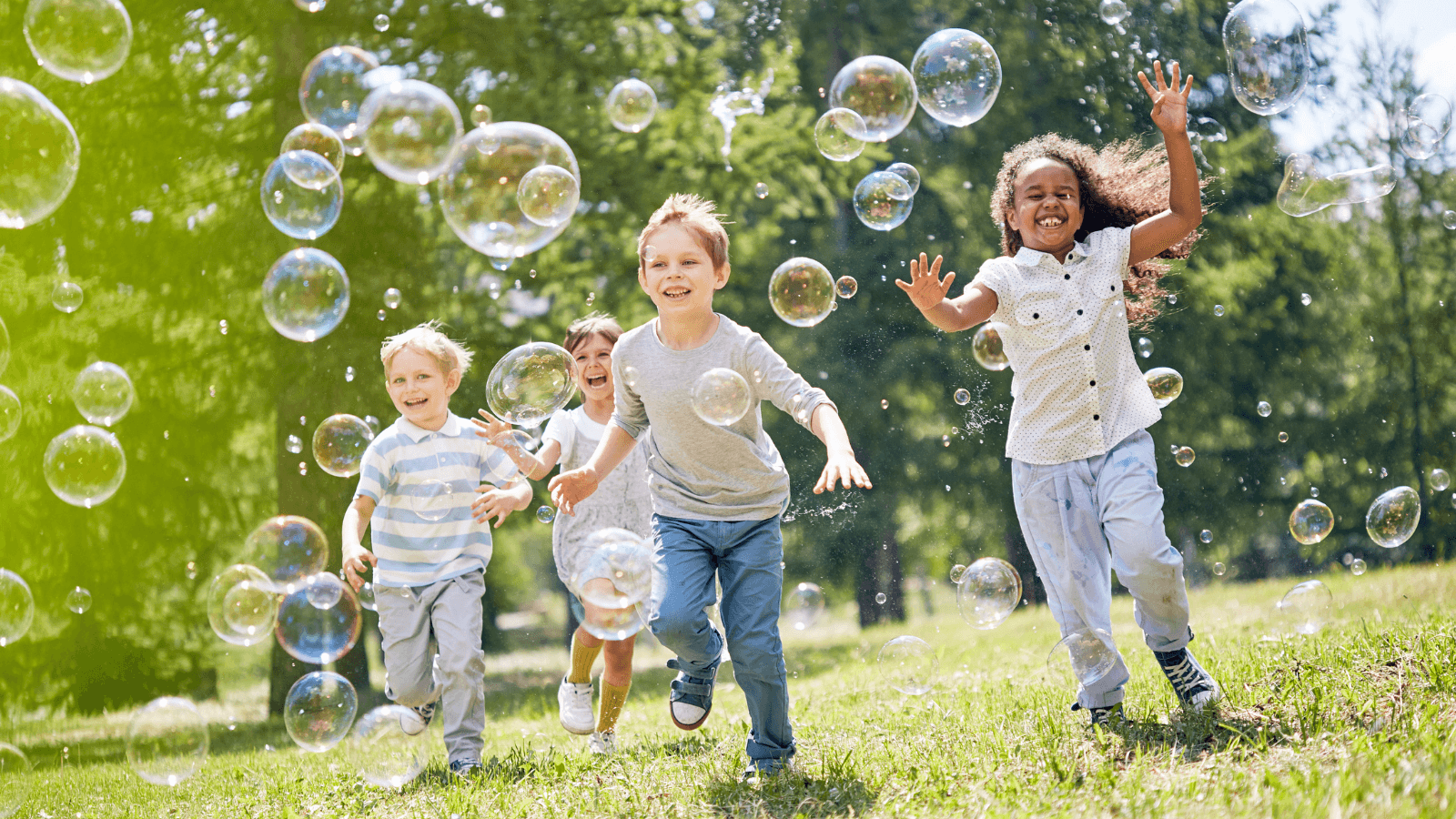 Photo of children playing outside with bubbles