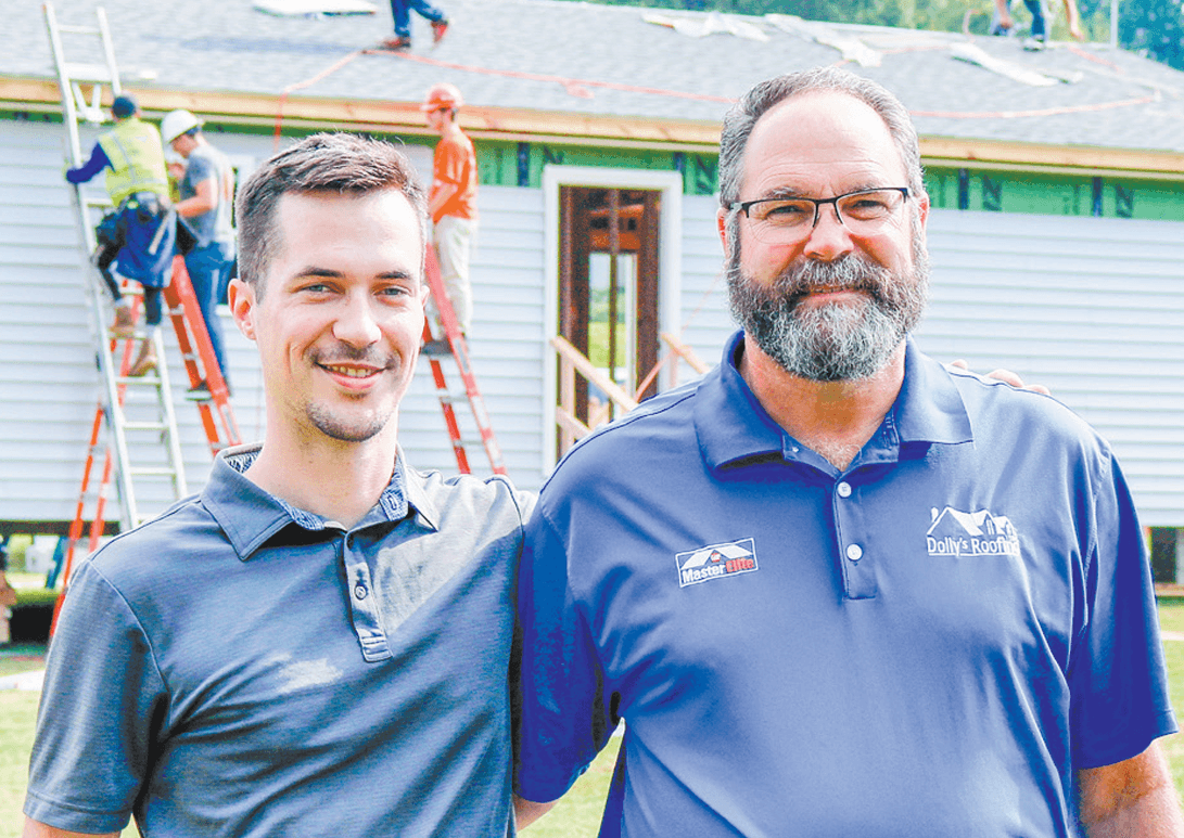 Dolly’s Roofing owner Charles Dolly is pictured with his son, Patrick. They are standing in front ofthe 2021 Homecoming Build House. Photo by Lauren Pierce of The Journal. 