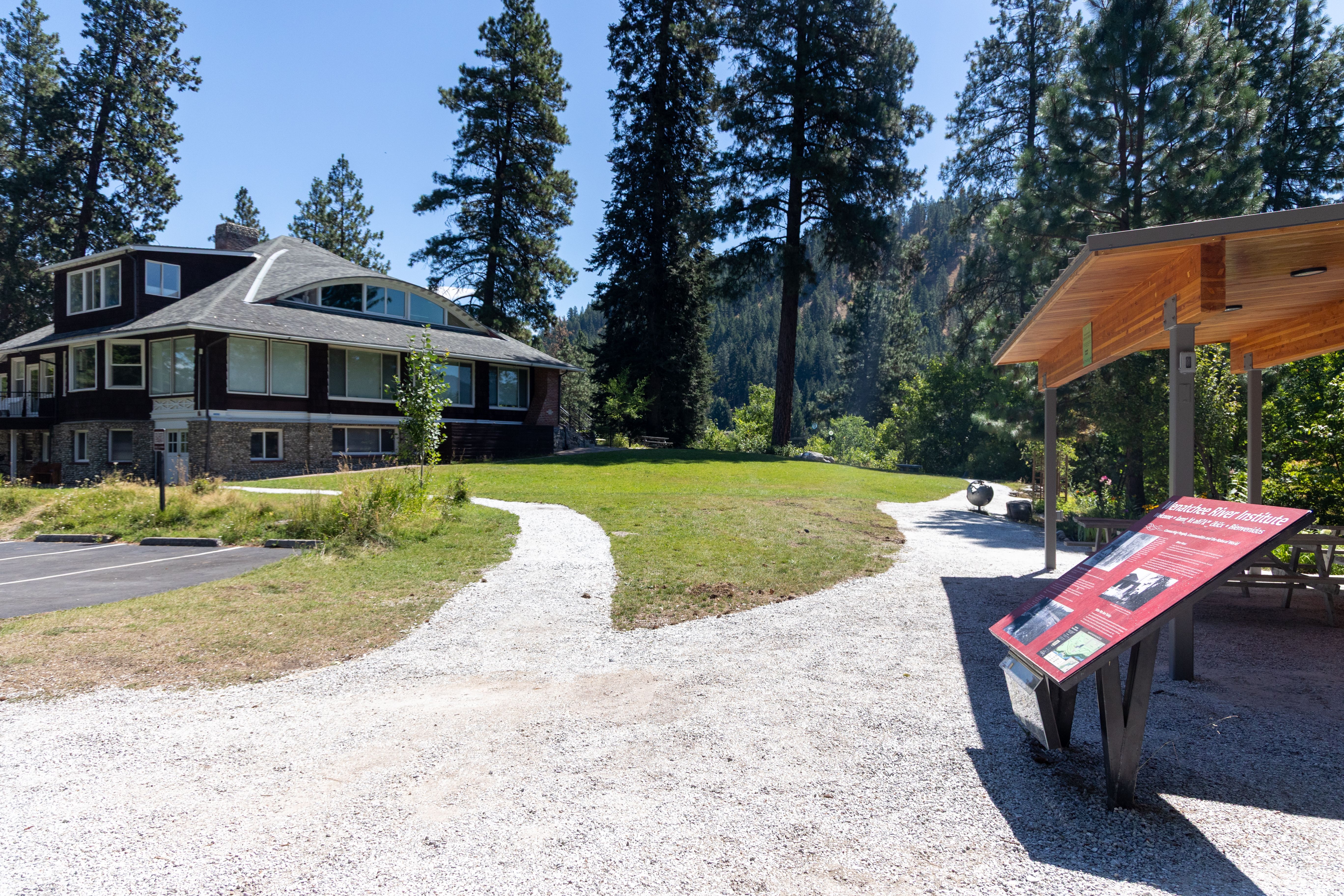 A scenic image of Wenatchee River Institute's River Haus building from the pathway near the Outdoor Classroom.