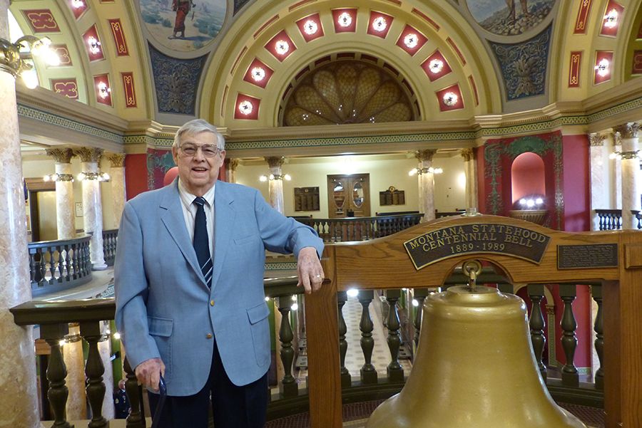 Older adult, male volunteer dressed up in a blue suit, smiling in Montana's state capitol building