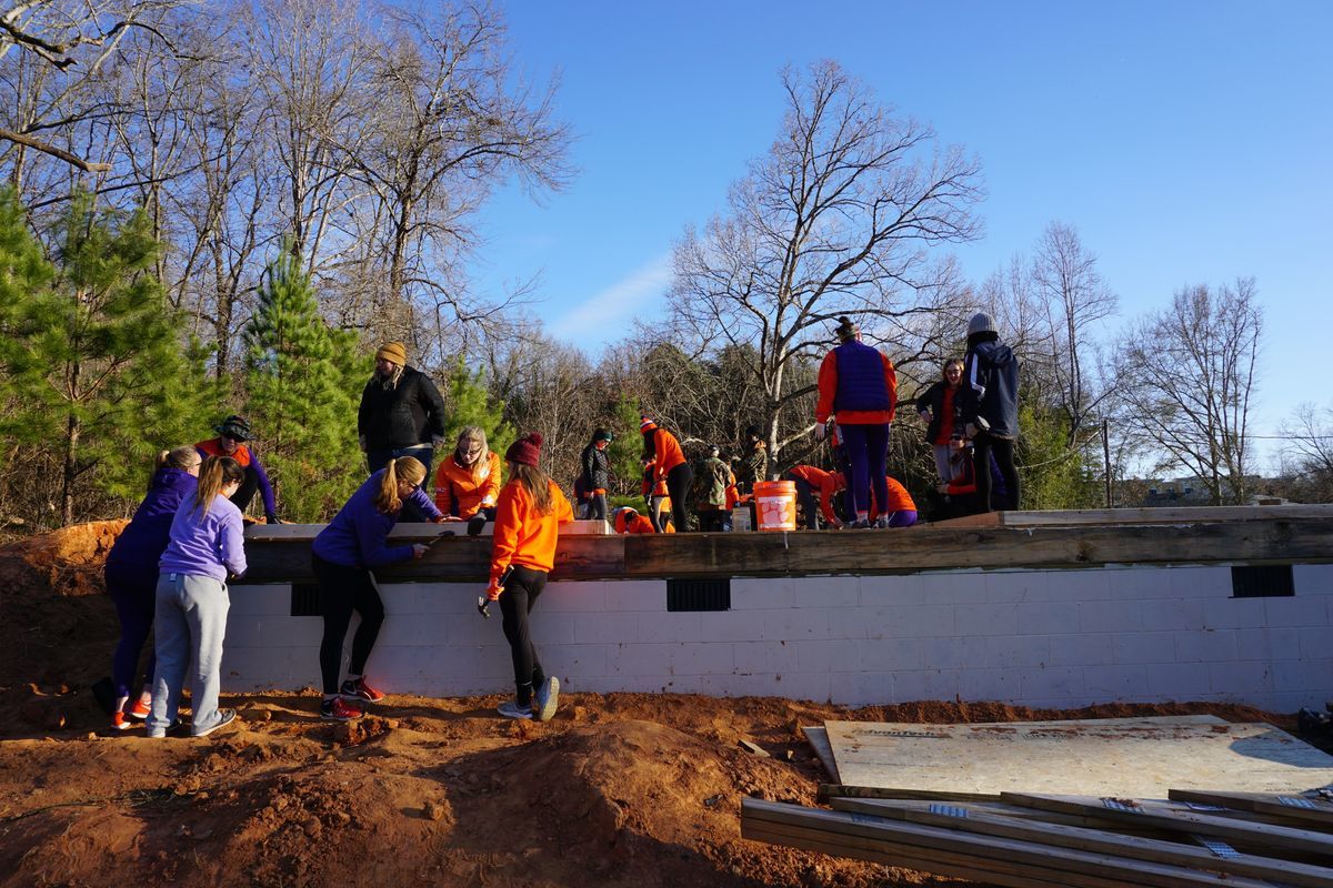 Several Clemson University Rowing team members work on the foundation of the Athletics Build. 