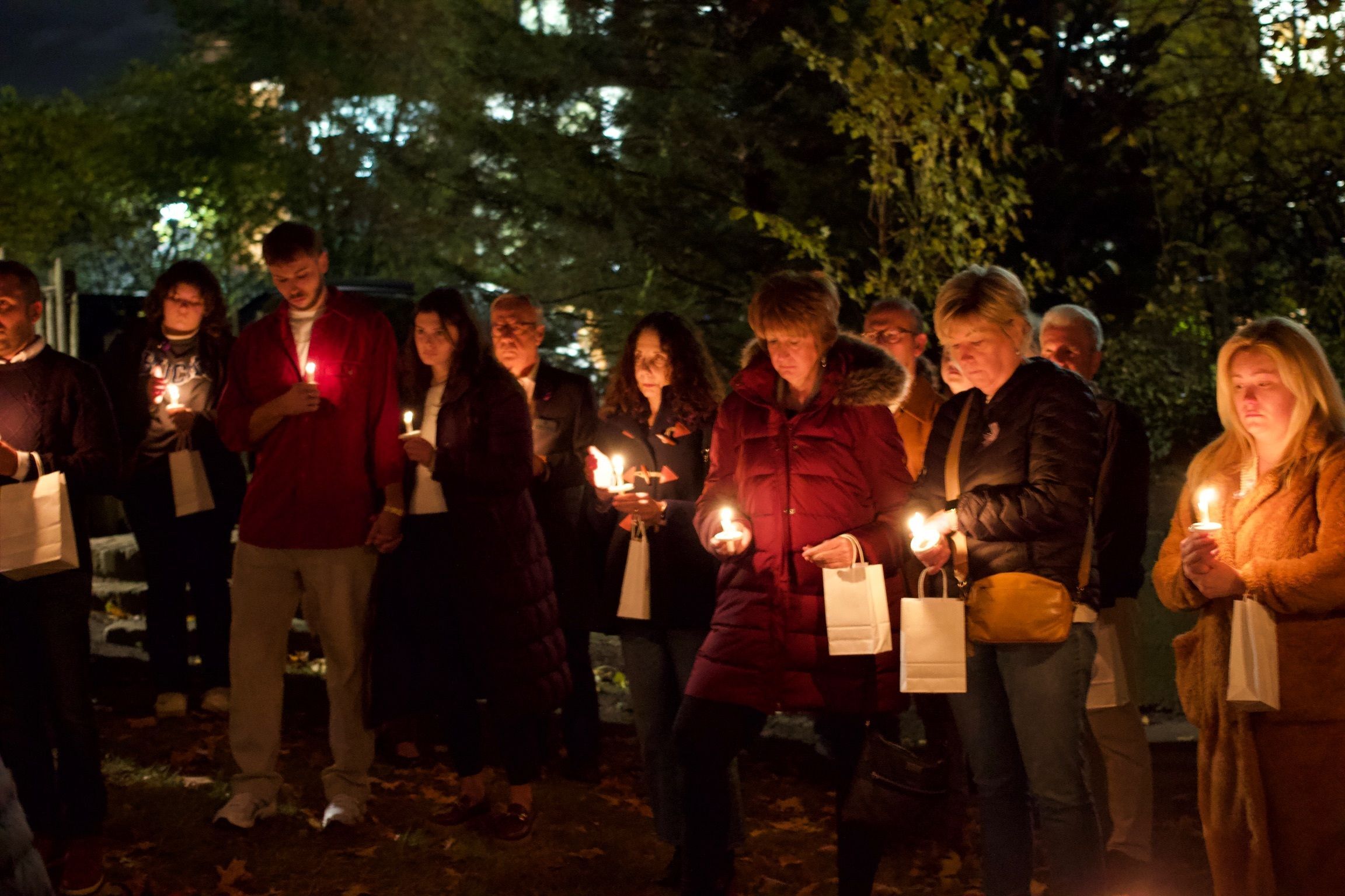 Community members, staff, and officials gather at the annual Night of Remembrance.