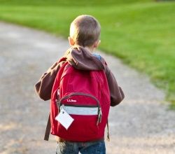 Child walking with backpack