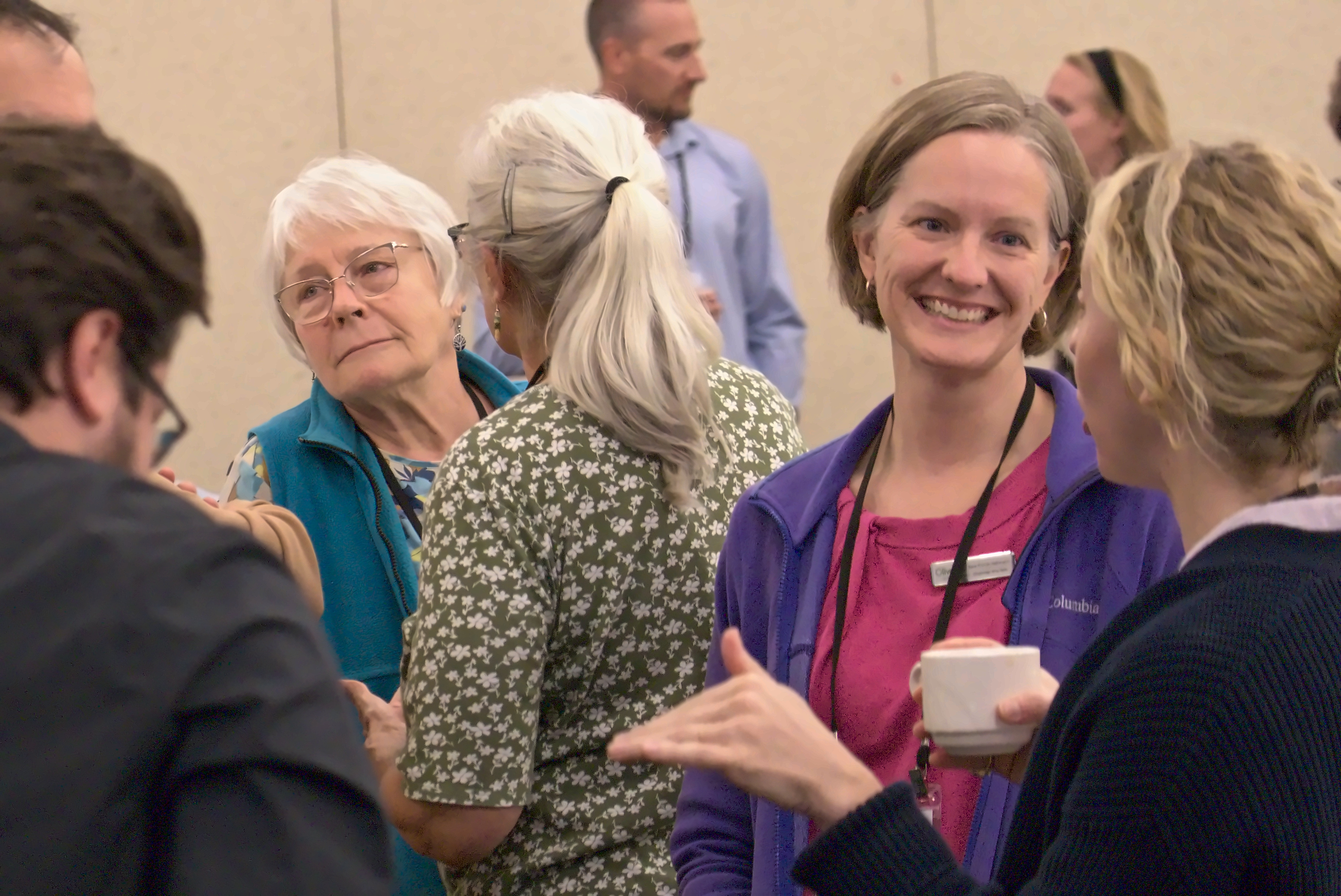Circularity Forum attendees talk and smile during a break.