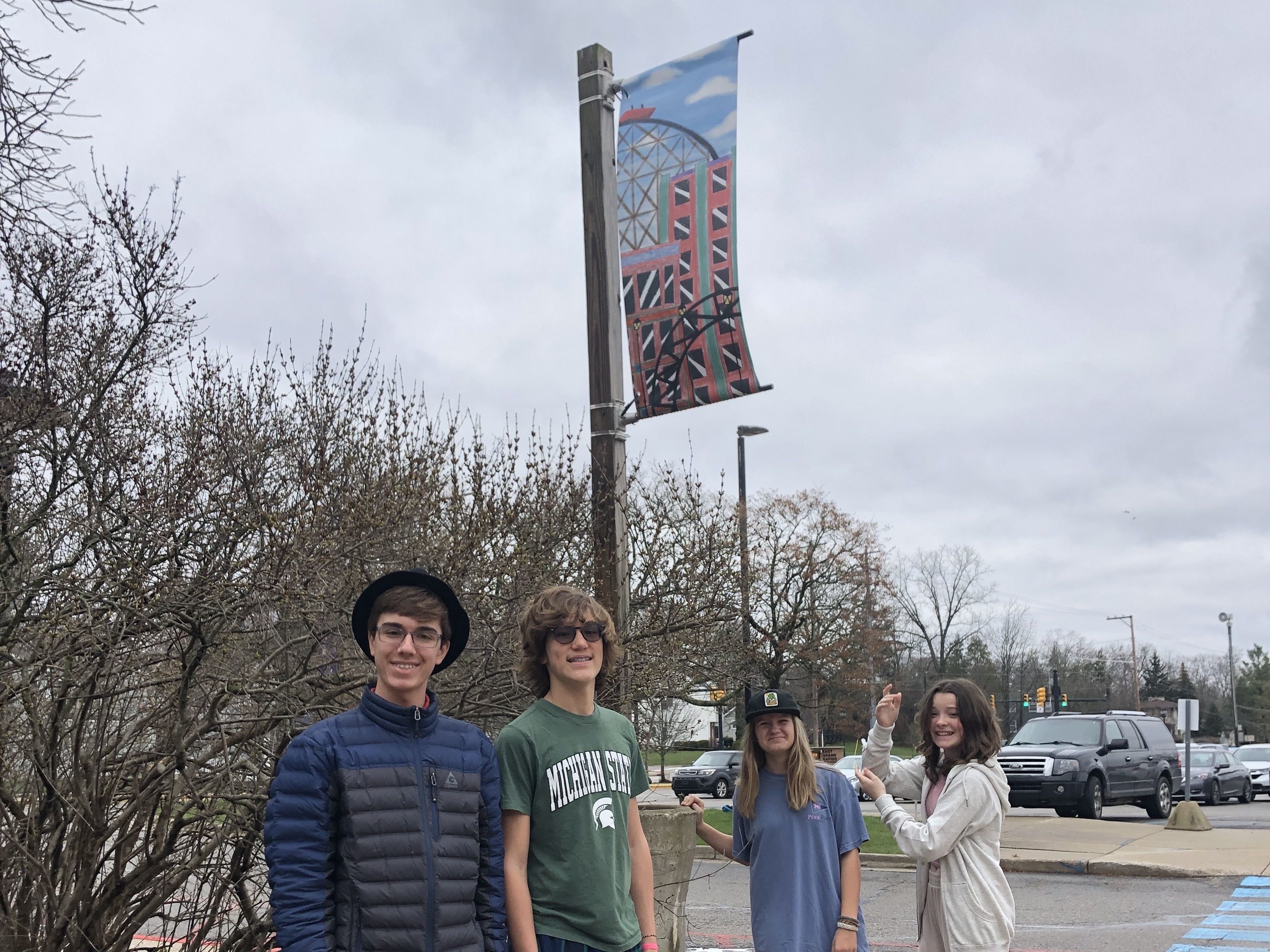 photo of middle school students with banner