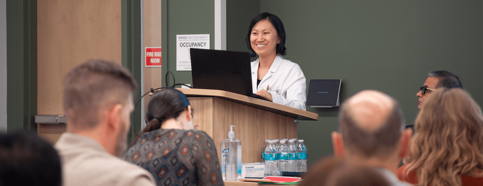 physician speaking at podium