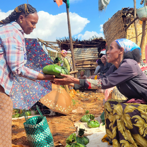 Adanech sells butter wrapped in a green leaf at the market for her business.