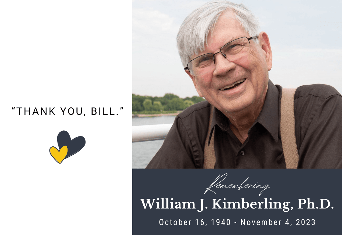 A photo of Bill Kimberling, a white man with short white hair, glasses, and suspenders over a brown collared shirt, smiling with a lake and trees visible in the background.