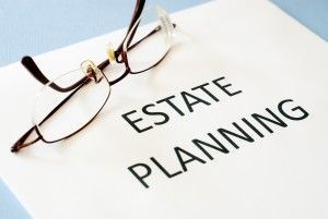 Glasses on a paper that reads "estate planning"