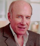 J. (Marty) McDonough. A man who is in his 70's wearing a suit and posing for the picture, there is text in the bottom right corner that reads "JM (Marty) McDonough"