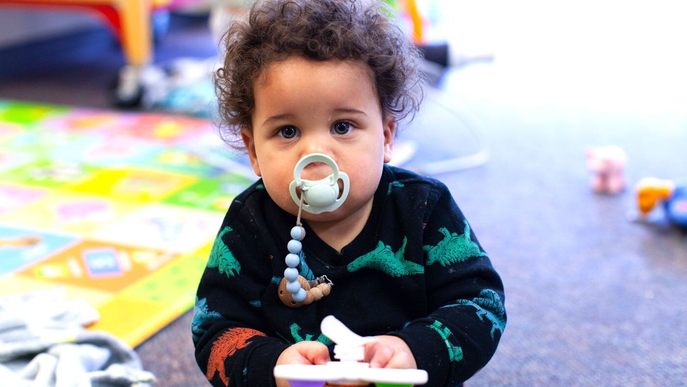 Young boy with pacifier and big eyes