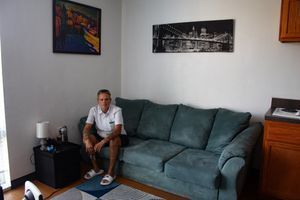 older man on couch in apartment