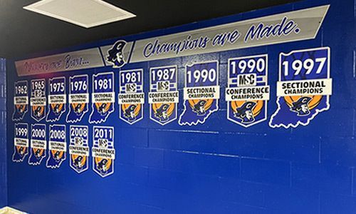 High school gym wall with state champ signs, state cut out signs, custom signs