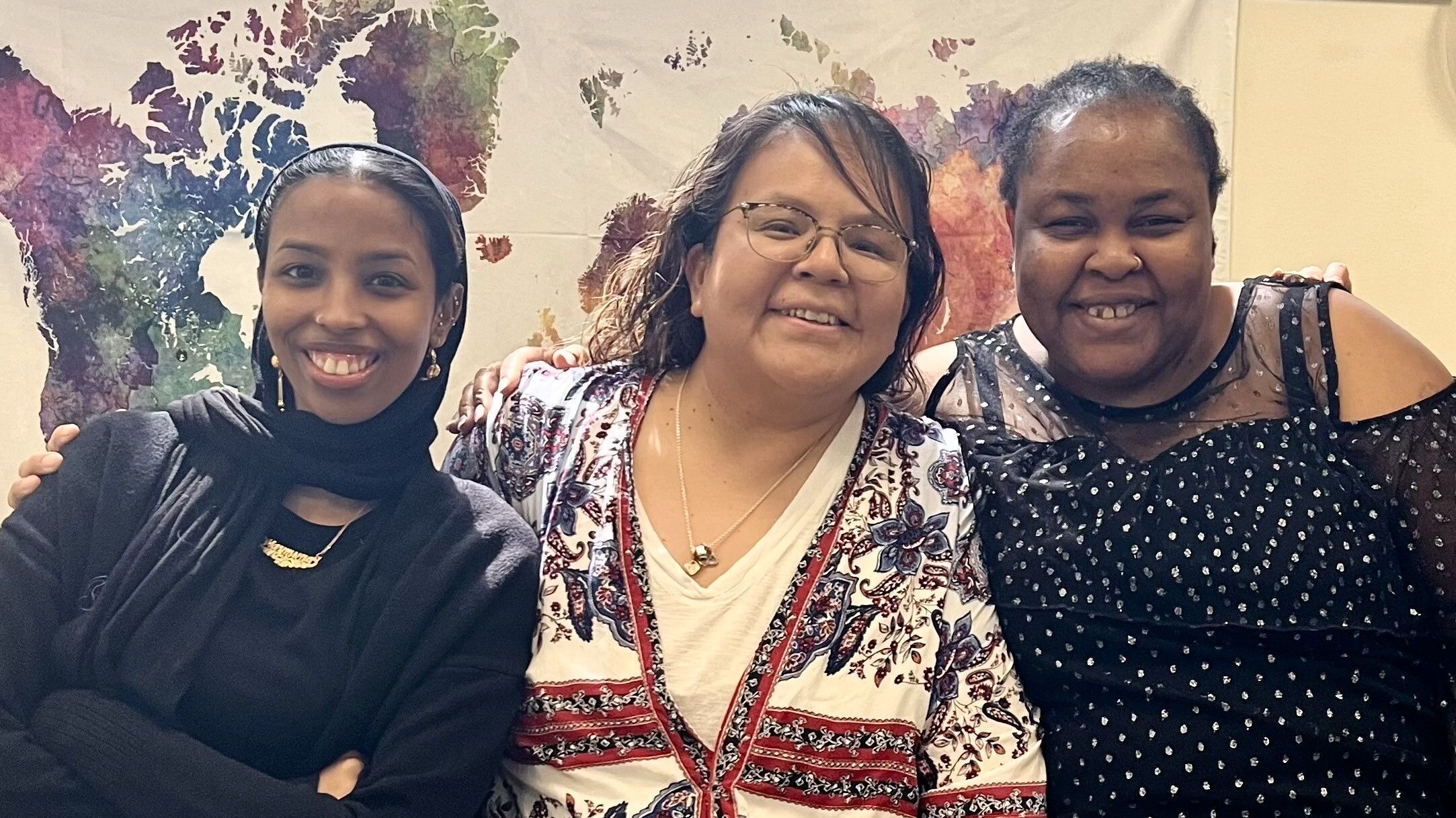 Three smiling interns of different races in Daily Work office