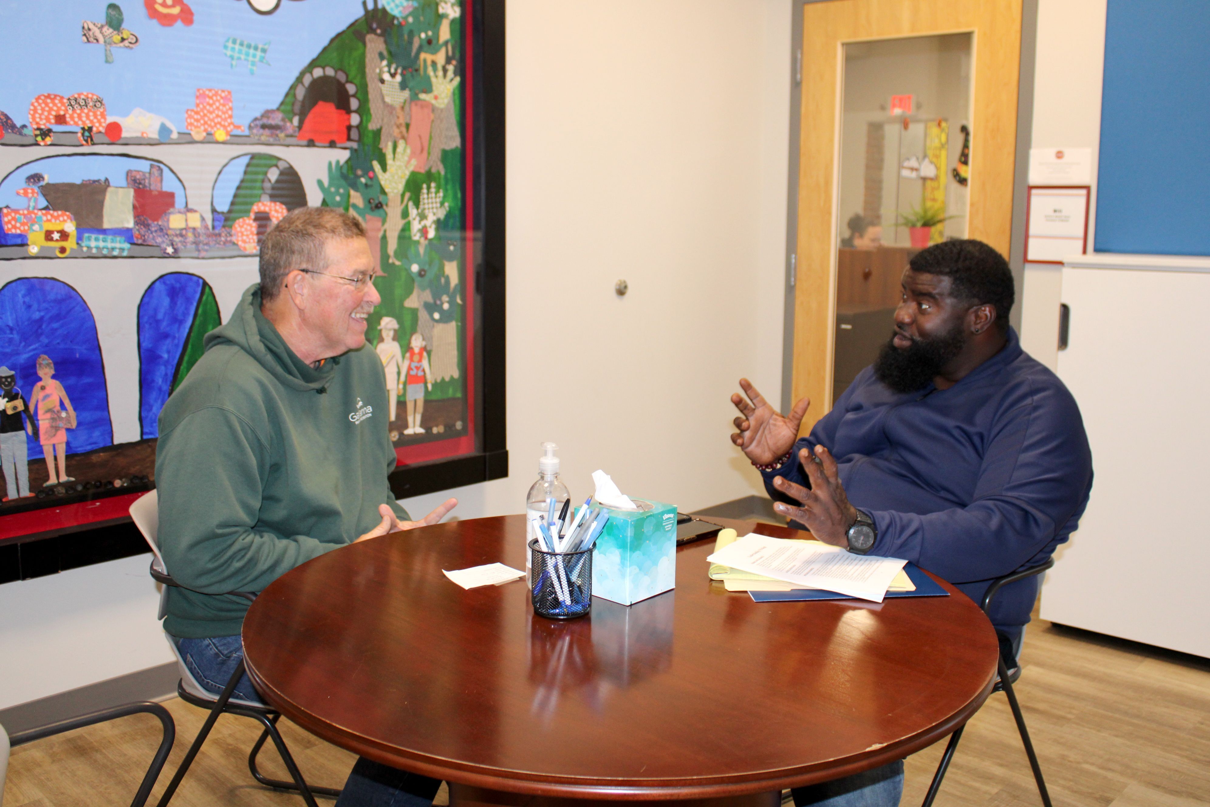 A case manager at Home for Families meets with a client to help them find housing