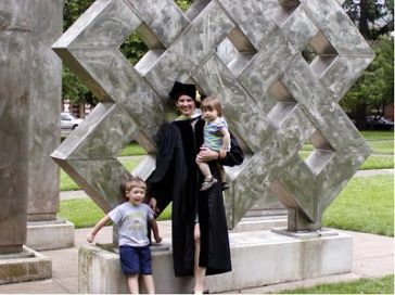 A picture of the blogger with her two kids after her graduation 