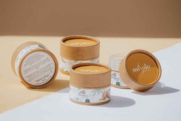 Sustainable e-commerce packaging featuring eco-friendly kraft paper cosmetic jars for a minimalist unboxing experience