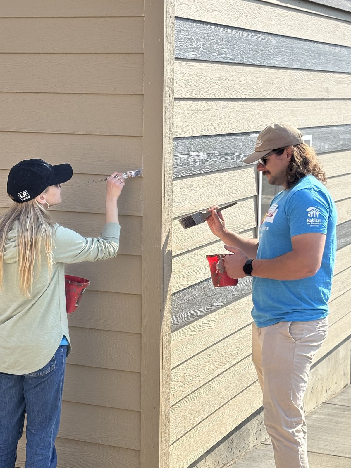 Habitat Colorado Build: Volunteers Painting outside of the garage
