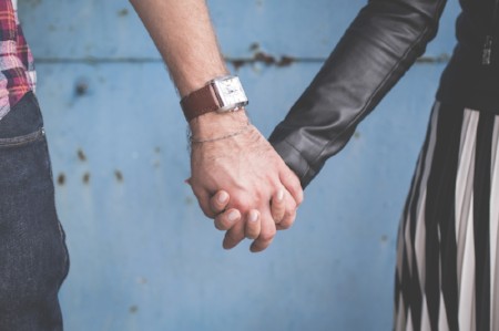 Two people holding hands